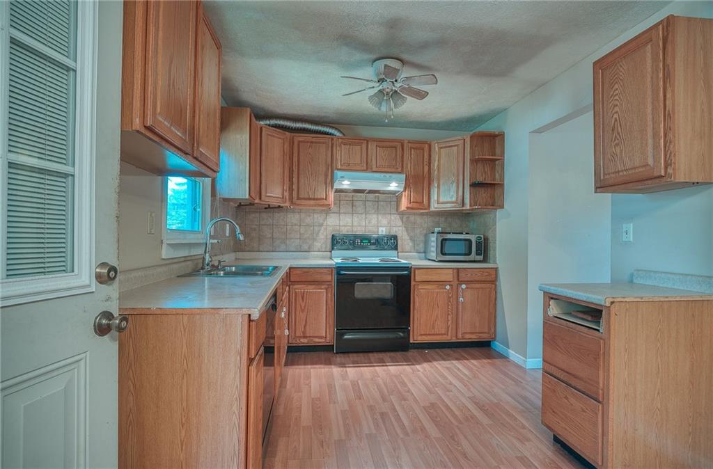 296 East Pike Road Indiana, PA 15701 - Photo 7 of 46 a kitchen with granite countertop a sink cabinets and wooden floor