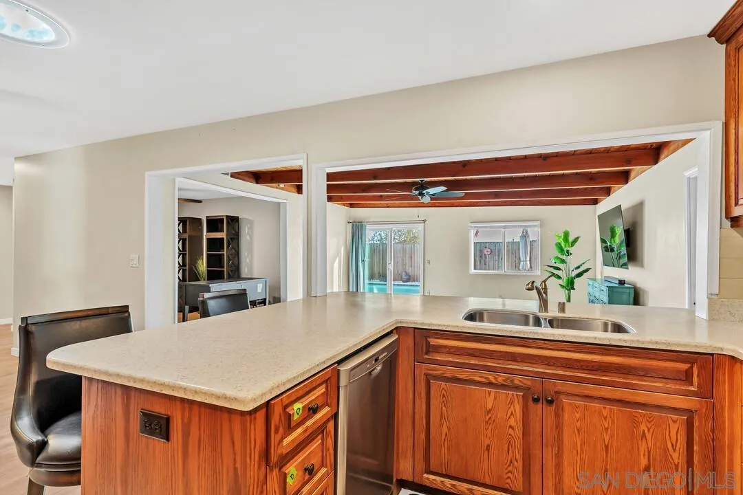 10143 Maple Tree Road Santee, CA 92071 - Photo 12 of 43 a kitchen with a sink and a refrigerator