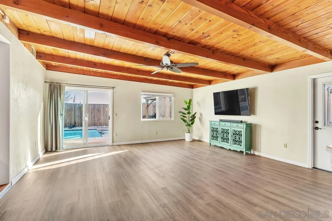 10143 Maple Tree Road Santee, CA 92071 - Photo 13 of 43 a view of an empty room with wooden floor and a window