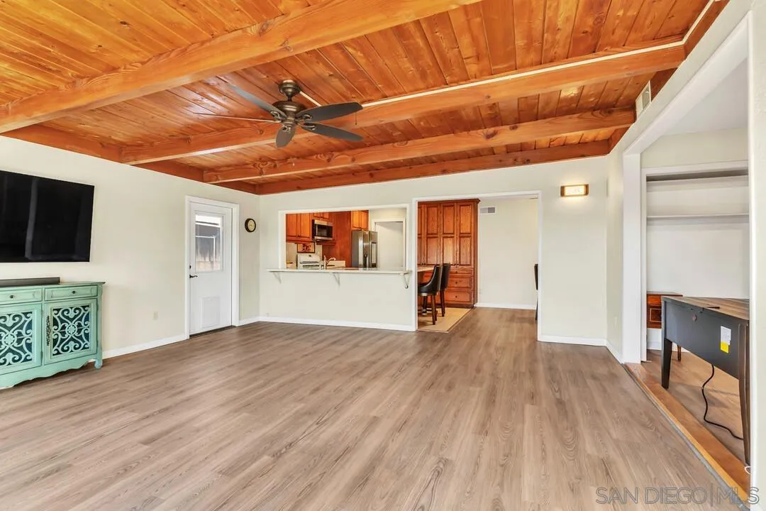 10143 Maple Tree Road Santee, CA 92071 - Photo 14 of 43 a view of an empty room with wooden floor and a window