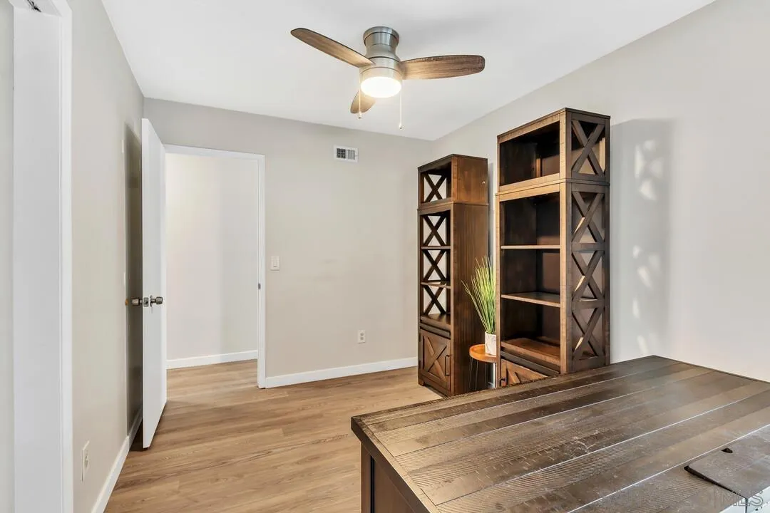 10143 Maple Tree Road Santee, CA 92071 - Photo 16 of 43 a view of a livingroom with wooden floor and a ceiling fan
