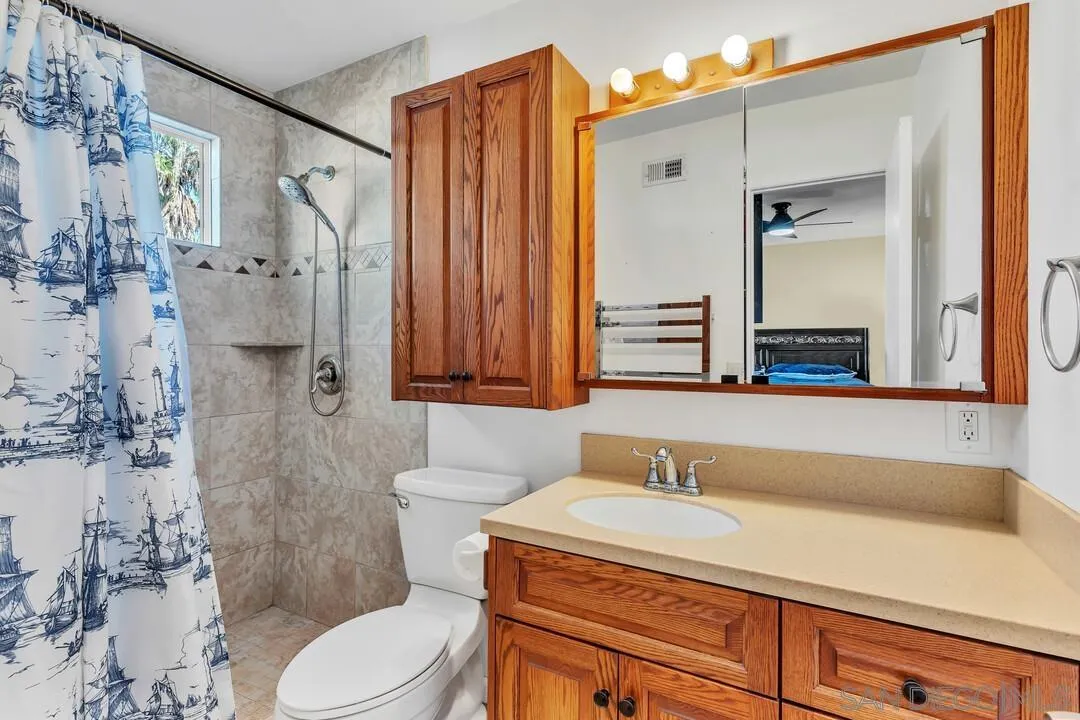 10143 Maple Tree Road Santee, CA 92071 - Photo 21 of 43 a bathroom with a sink a toilet and shower