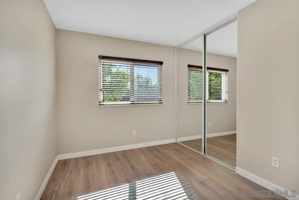 10143 Maple Tree Road Santee, CA 92071 - Photo 23 of 43 an empty room with wooden floor closet and windows