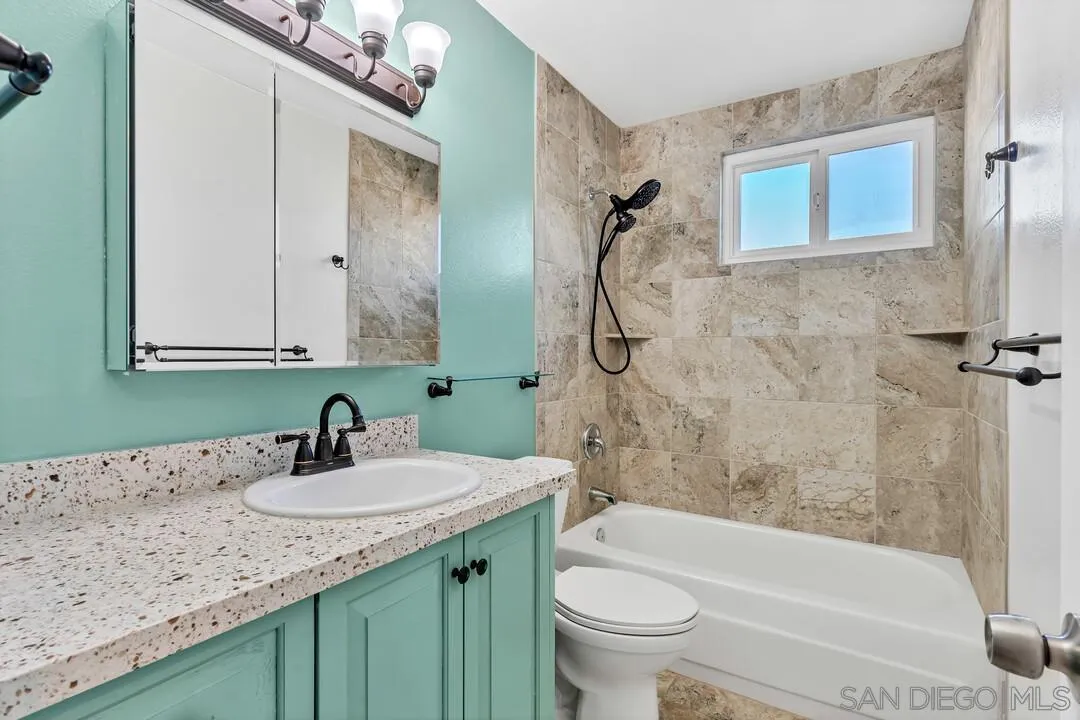 10143 Maple Tree Road Santee, CA 92071 - Photo 25 of 43 a bathroom with a granite countertop sink a toilet and bathtub