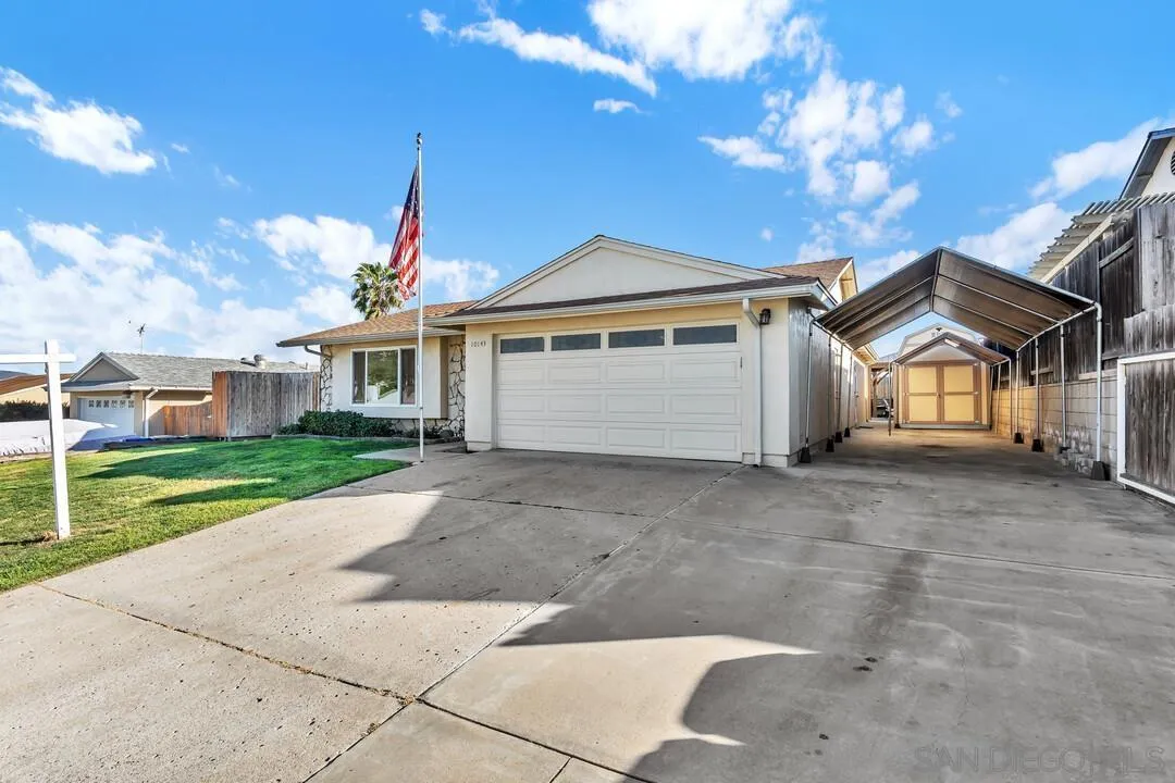 10143 Maple Tree Road Santee, CA 92071 - Photo 3 of 43 a front view of a house with a yard and garage