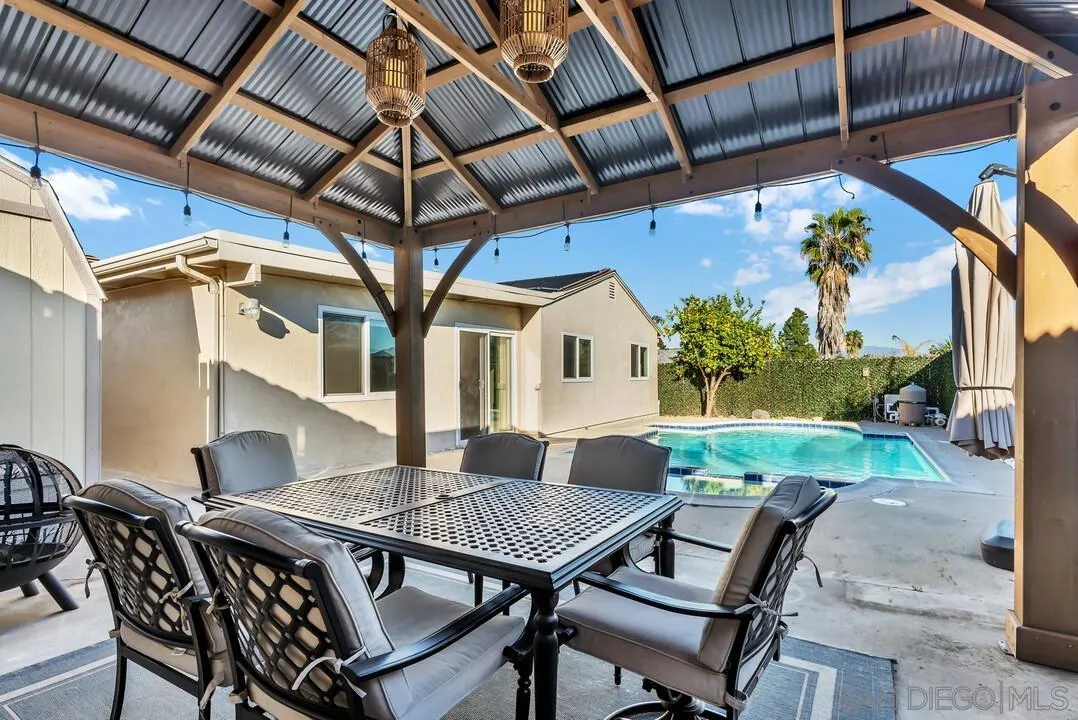 10143 Maple Tree Road Santee, CA 92071 - Photo 33 of 43 a view of a patio with table and chairs and potted plants