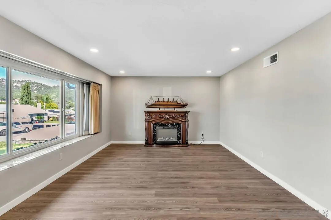 10143 Maple Tree Road Santee, CA 92071 - Photo 5 of 43 a view of an empty room with wooden floor and a window