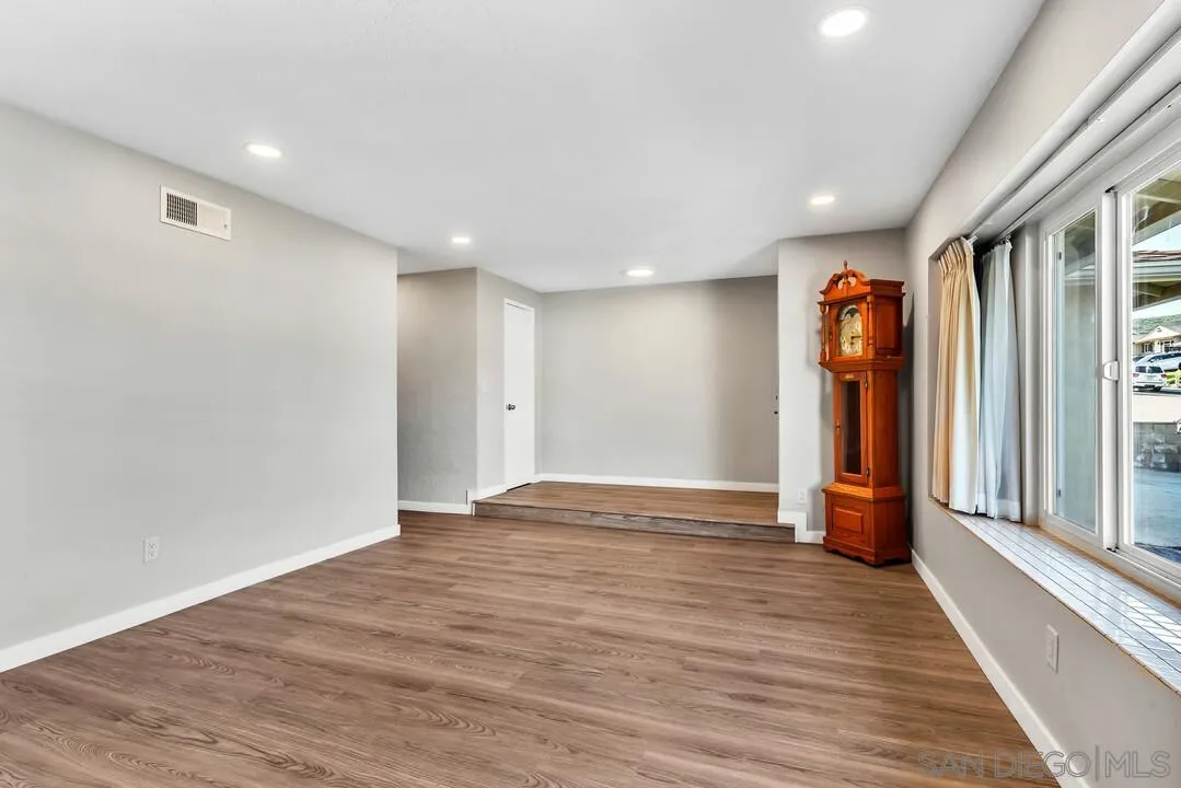 10143 Maple Tree Road Santee, CA 92071 - Photo 6 of 43 a view of an empty room with wooden floor and a window