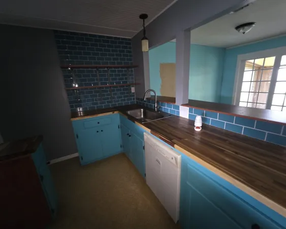 a kitchen with a sink and cabinets