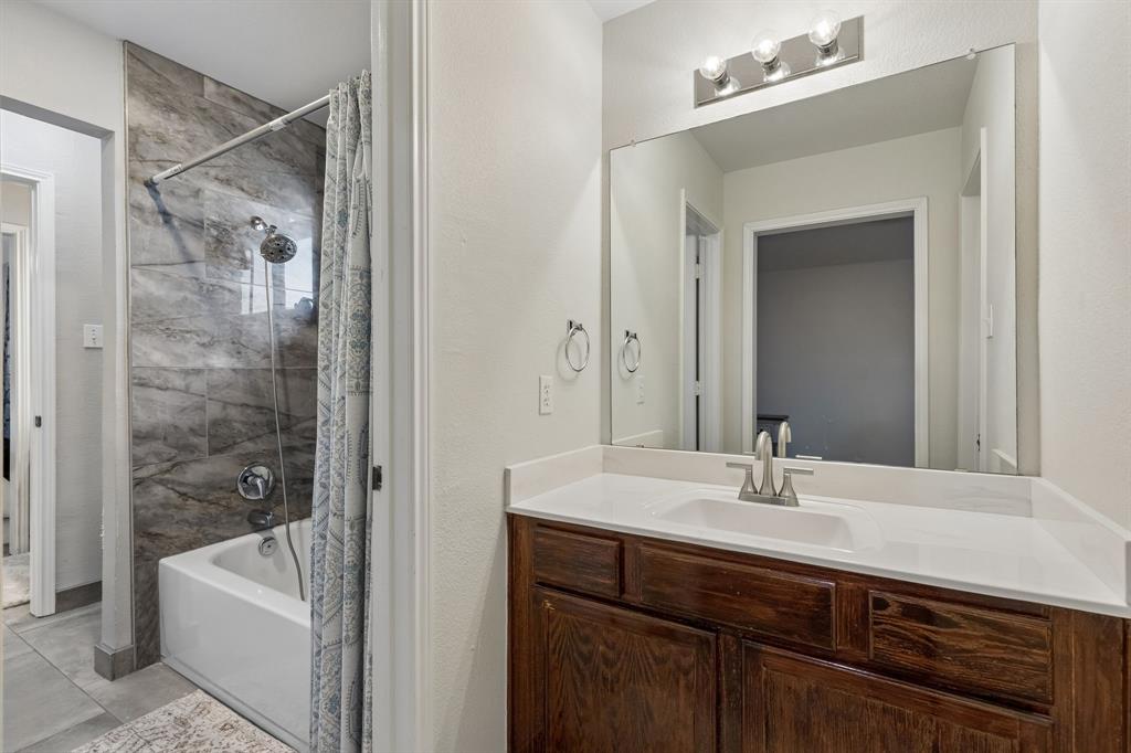 129 Timberbluff Lane Murphy, TX 75094 - Photo 29 of 34 a bathroom with a sink a mirror and a bathtub