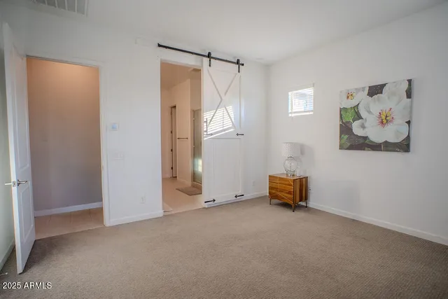 an empty room with windows and closet