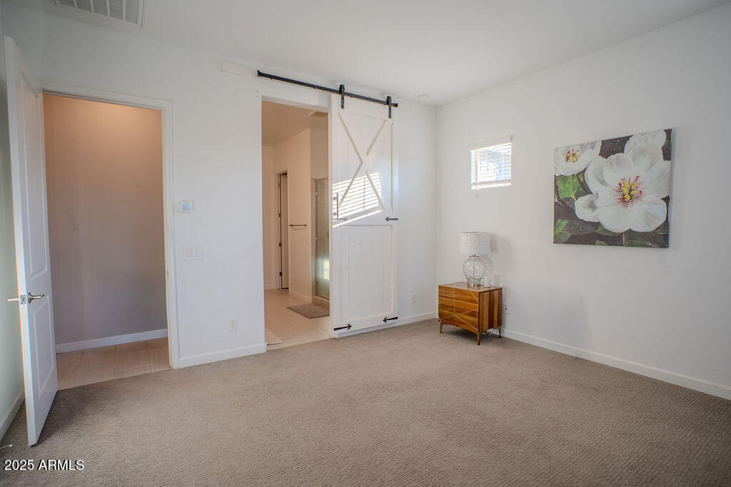 16979 West Alameda Road Surprise, AZ 85387 - Photo 13 of 33 an empty room with windows and closet