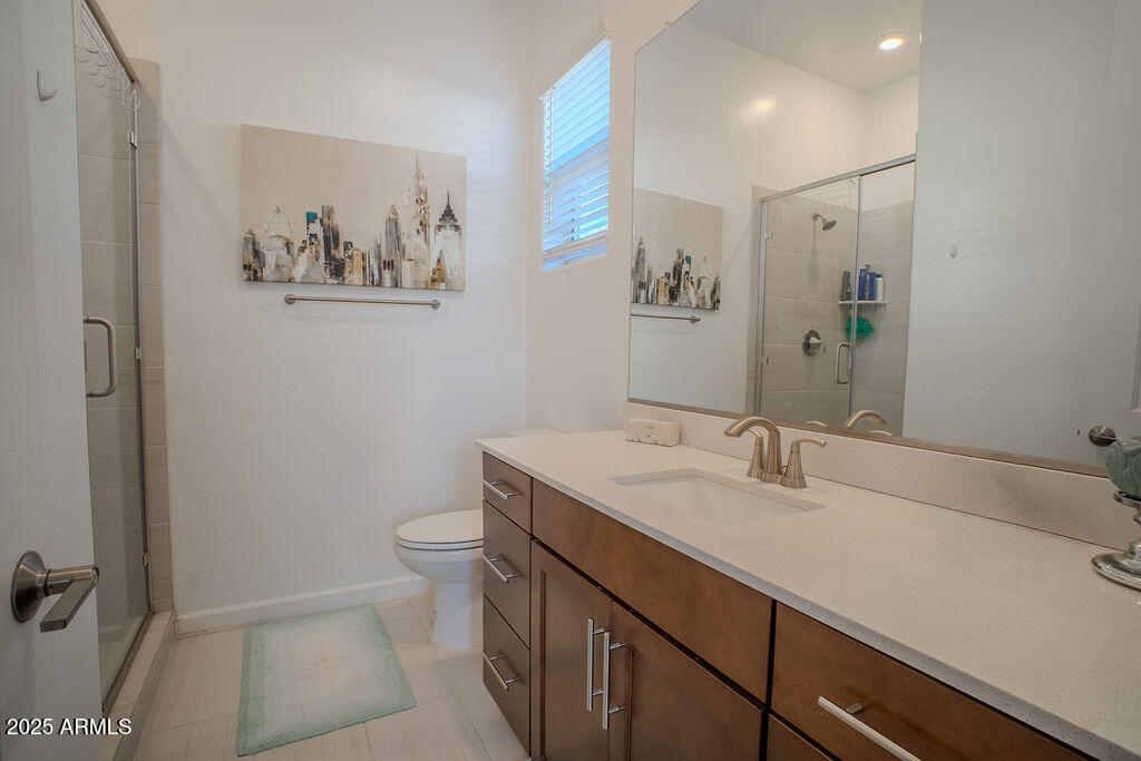 16979 West Alameda Road Surprise, AZ 85387 - Photo 17 of 33 a bathroom with a sink a toilet and mirror