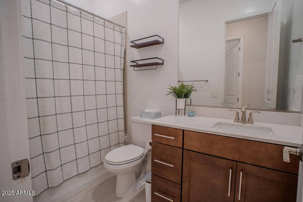 16979 West Alameda Road Surprise, AZ 85387 - Photo 22 of 33 a bathroom with a toilet a sink and shower