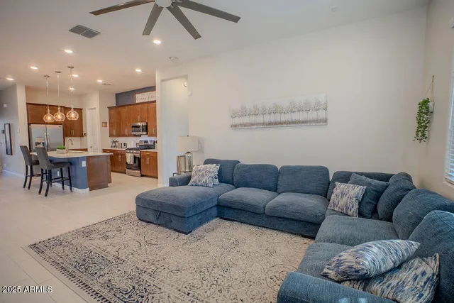a living room with furniture kitchen view and a dining table