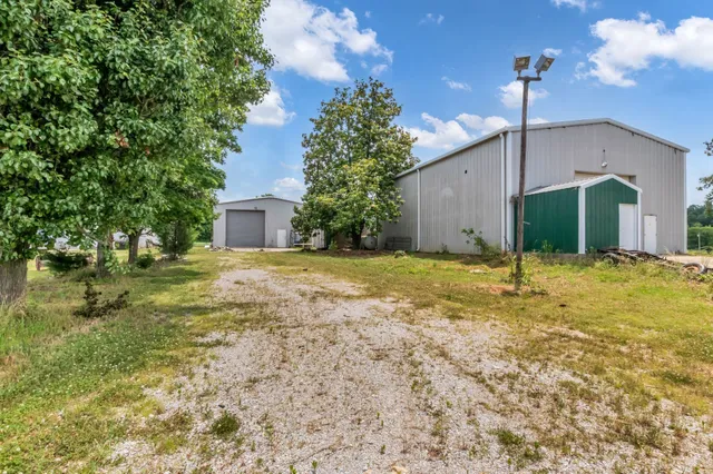 a view of a house with backyard and tree
