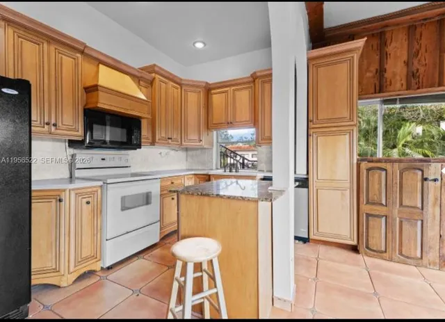a kitchen with a refrigerator stove and microwave