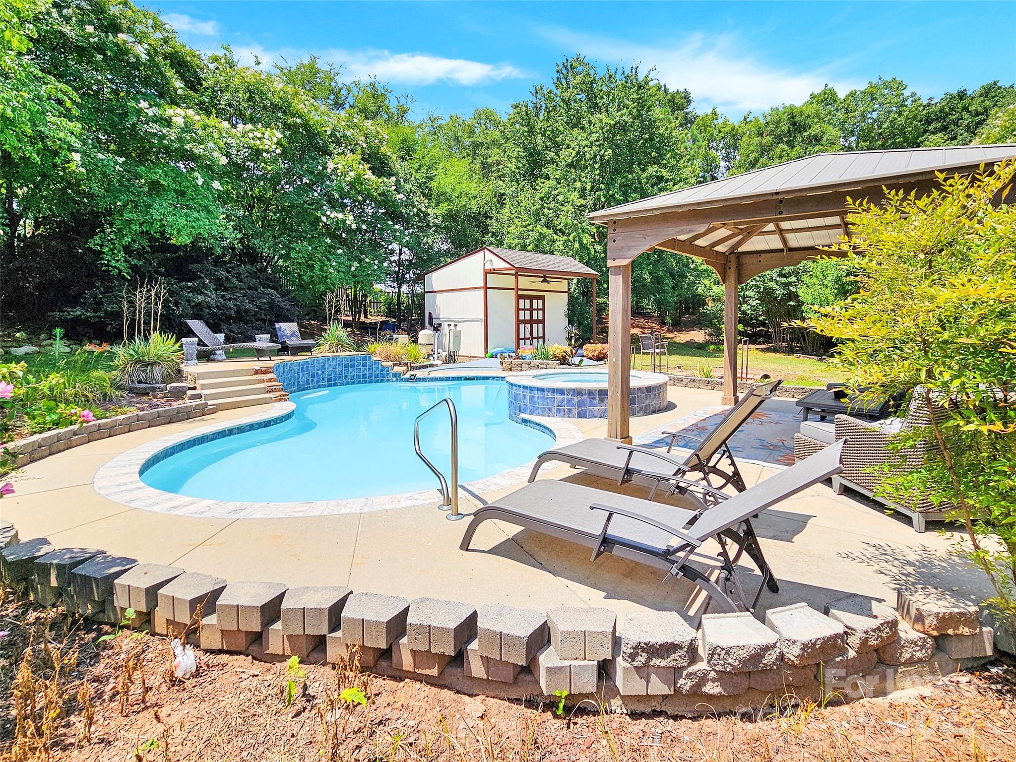 8534 Headford Road Charlotte, NC 28277 - Photo 3 of 48 a view of a swimming pool with a patio