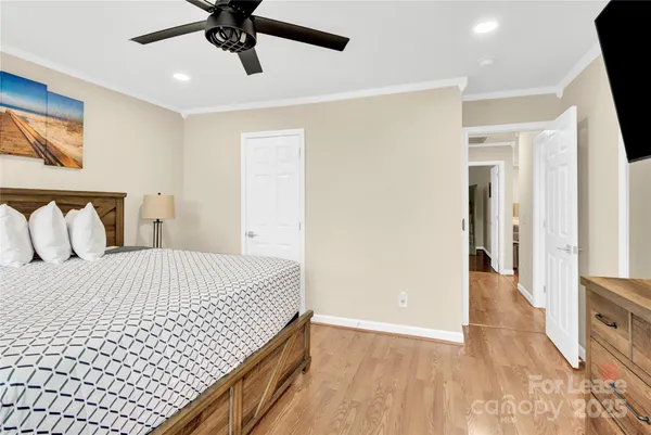 a bedroom with a bed and a ceiling fan