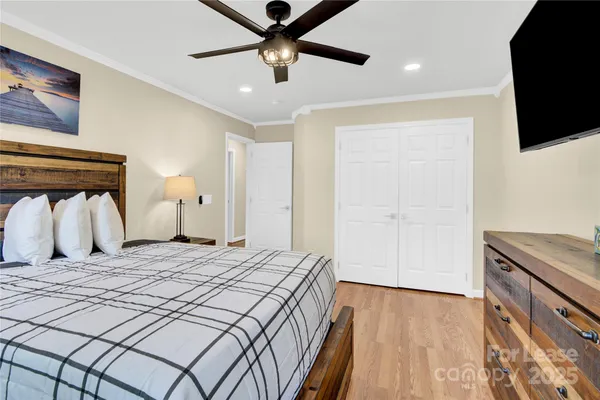 a bedroom with a bed and a flat screen tv