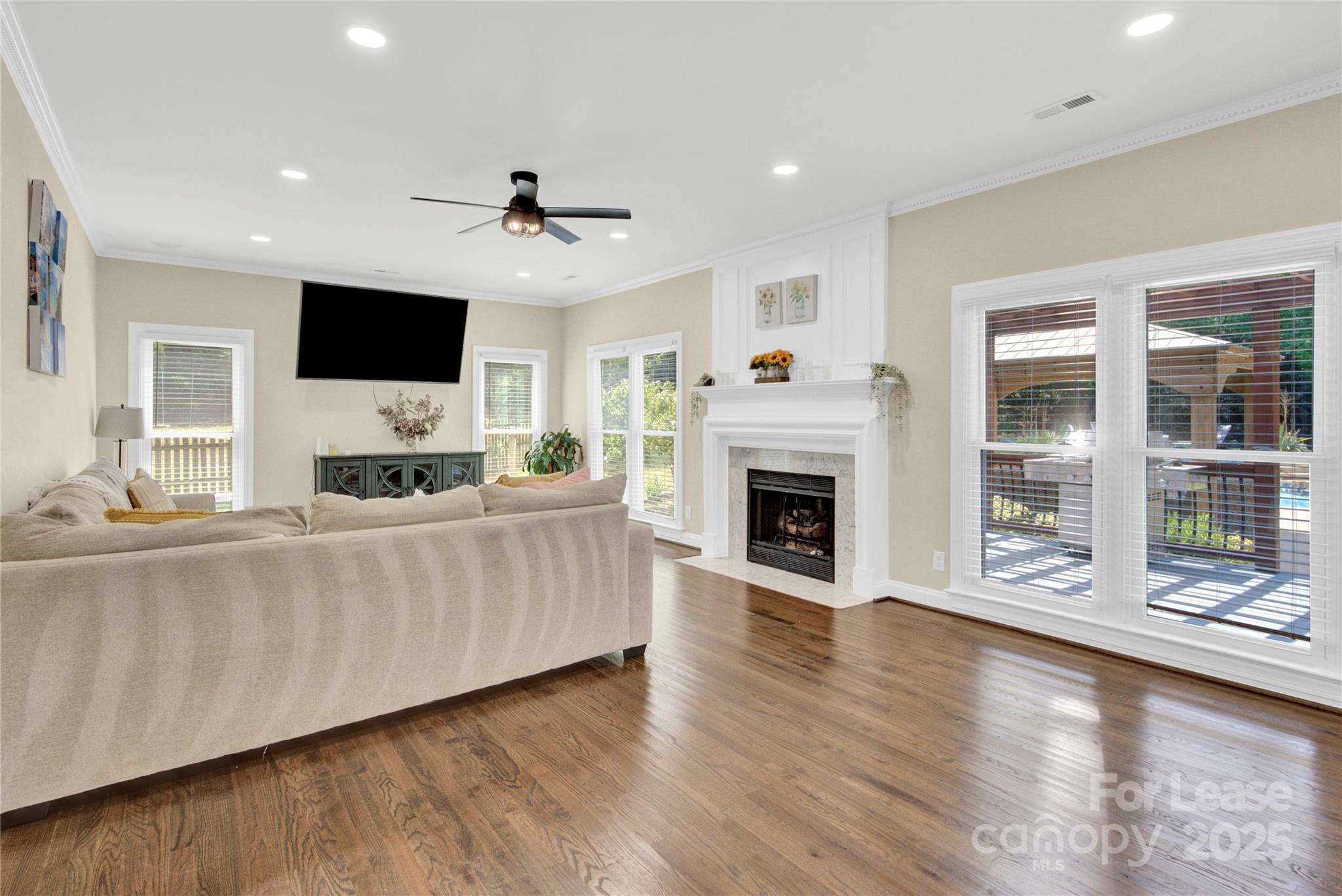 8534 Headford Road Charlotte, NC 28277 - Photo 36 of 48 a living room with furniture a flat screen tv and a fireplace