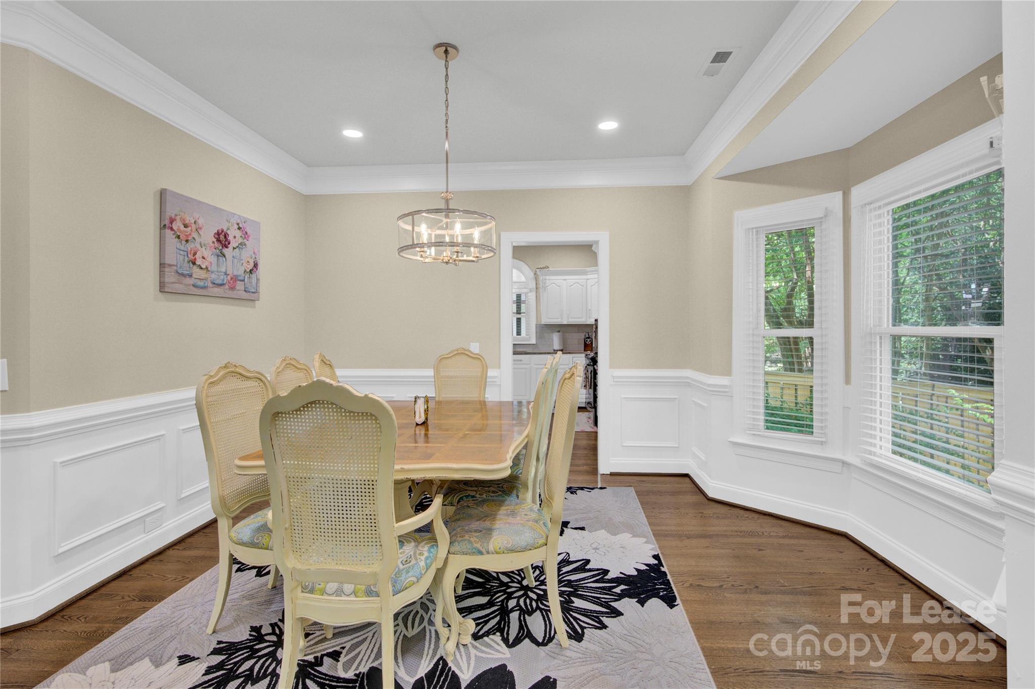 8534 Headford Road Charlotte, NC 28277 - Photo 47 of 48 a view of a dining room with furniture a chandelier and wooden floor