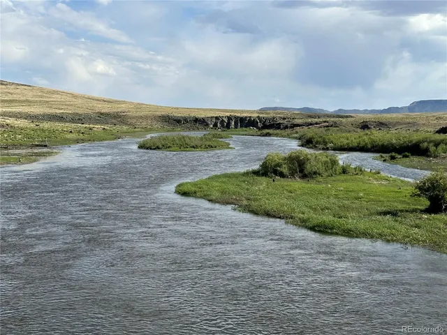 a view of a field with an ocean