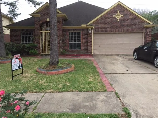 a front view of a house with a yard and potted plants