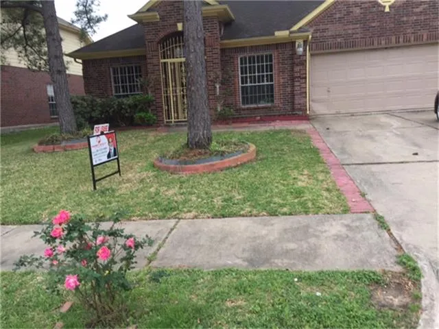 a view of a house with a yard and pathway