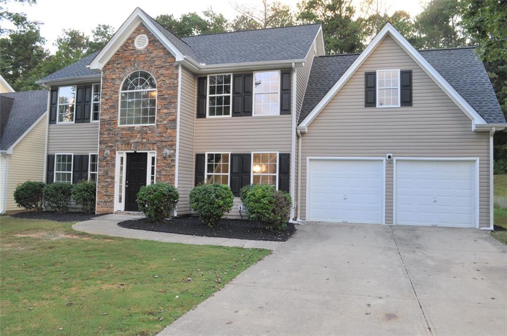 2242 Corkscrew Way Villa Rica, GA 30180 - Photo 1 of 1 a front view of a house with a yard and garage