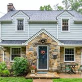 a front view of a house with outdoor seating