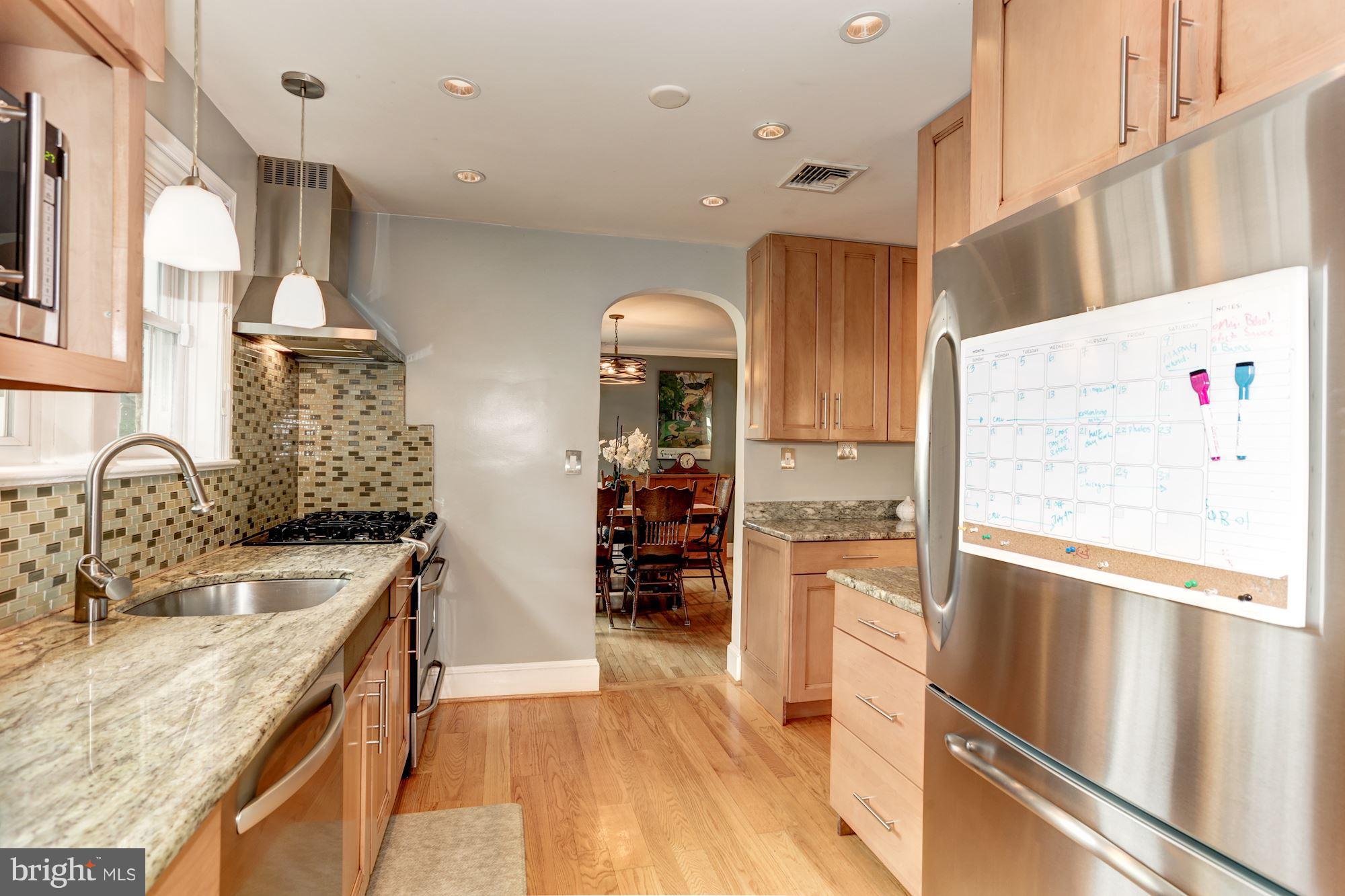 2706 Ridge Rd Drive Alexandria, VA 22302 - Photo 11 of 30 a kitchen with granite countertop a sink stainless steel appliances and cabinets