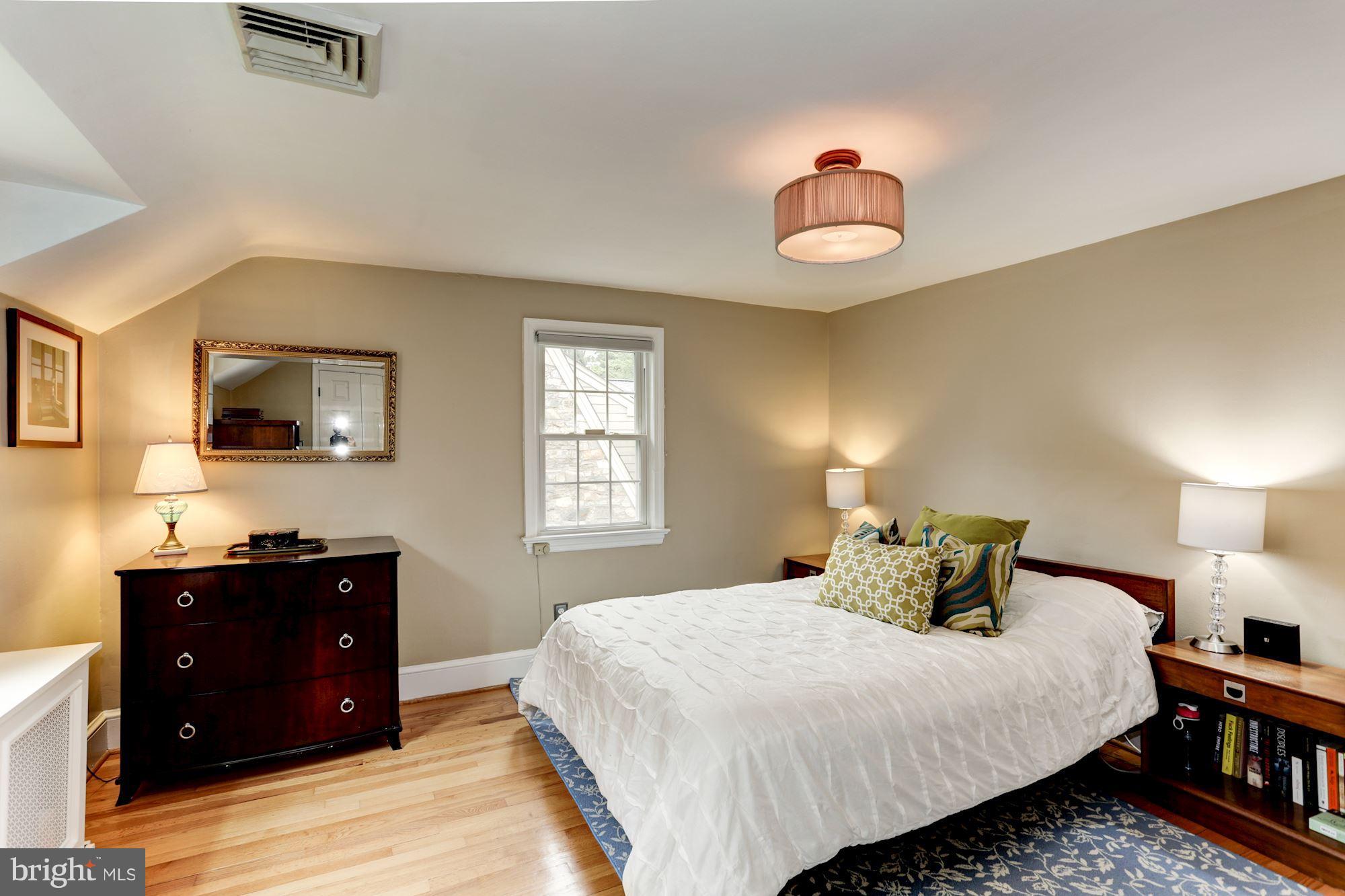 2706 Ridge Rd Drive Alexandria, VA 22302 - Photo 16 of 30 a bedroom with a bed and a flat tv screen on dresser