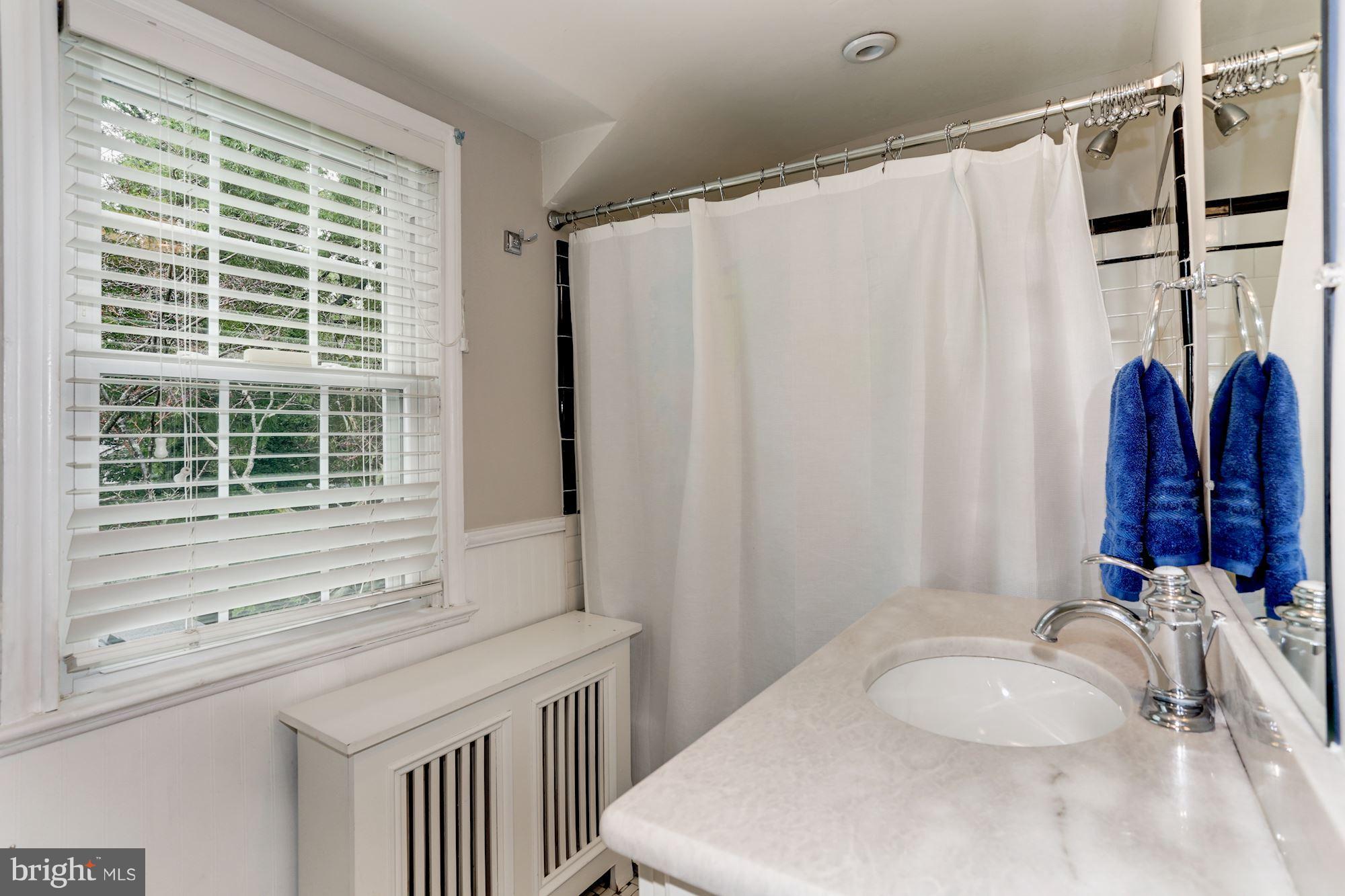 2706 Ridge Rd Drive Alexandria, VA 22302 - Photo 21 of 30 a bathroom with a granite countertop sink and a mirror
