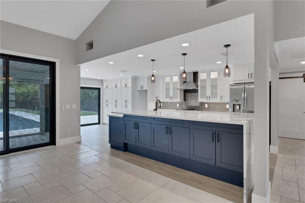 1806 Princess Court Naples, FL 34110 - Photo 11 of 40 a large bathroom with a large mirror vanity and shower