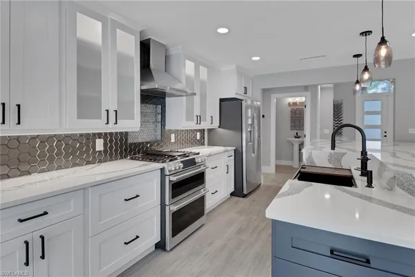 a kitchen with stainless steel appliances a sink stove and refrigerator