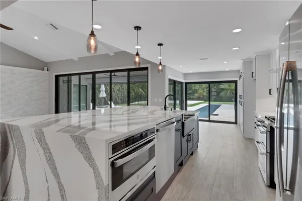 a kitchen with stainless steel appliances granite countertop a sink and stove