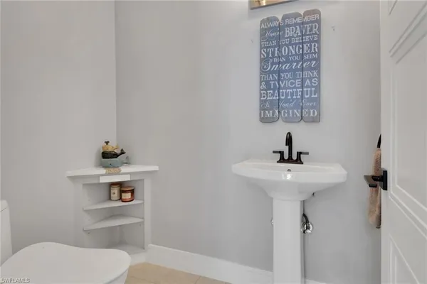 a bathroom with a sink a toilet and mirror