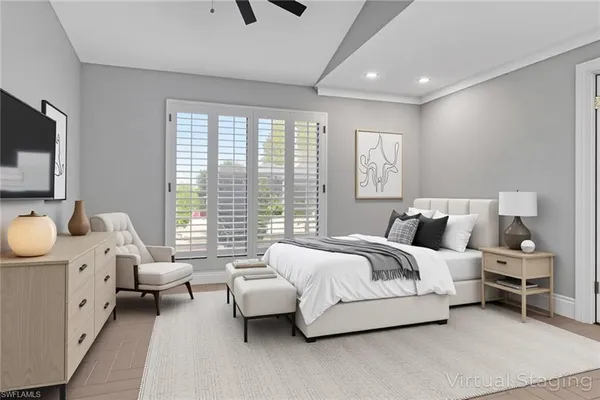 a spacious bedroom with a bed and a flat screen tv