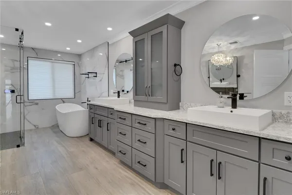 a bathroom with a double vanity sink and a mirror