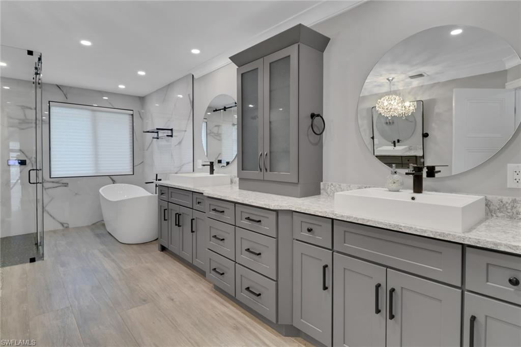 1806 Princess Court Naples, FL 34110 - Photo 24 of 40 a bathroom with a double vanity sink and a mirror