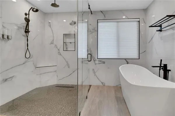 a bathroom with a bathtub and a shower