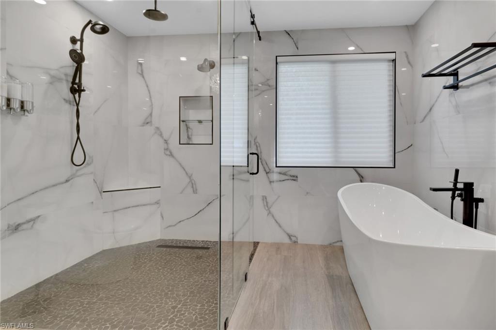 1806 Princess Court Naples, FL 34110 - Photo 26 of 40 a bathroom with a bathtub and a shower