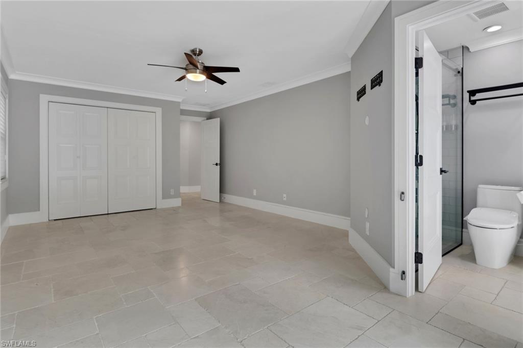 1806 Princess Court Naples, FL 34110 - Photo 30 of 40 a view of a room with a ceiling fan and shower