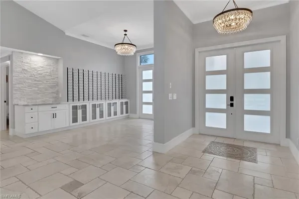 an empty room with windows and entrance