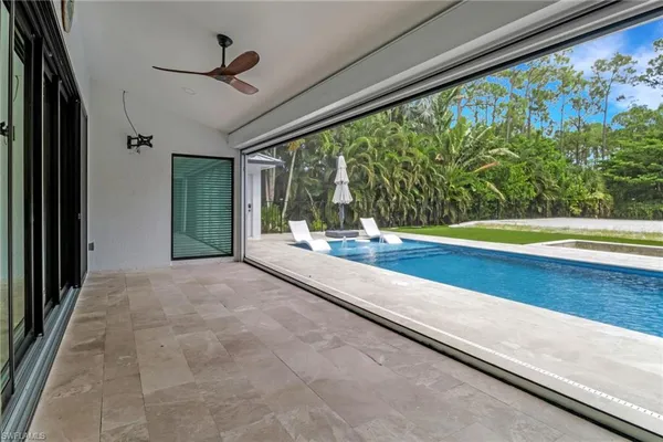 a view of a living room and floor to ceiling windows