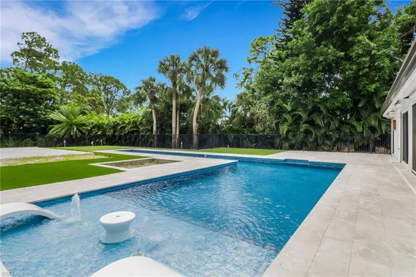 a view of a swimming pool with a patio