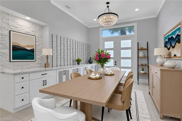 a view of a dining room with furniture and chandelier