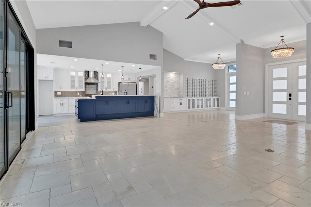 1806 Princess Court Naples, FL 34110 - Photo 6 of 40 a kitchen with stainless steel appliances a refrigerator and a sink