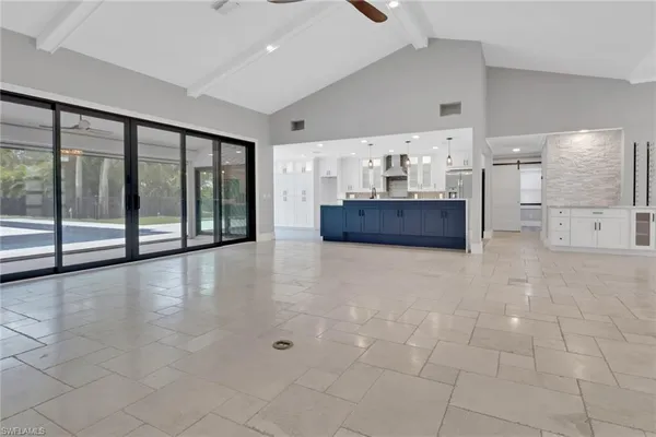 a large room with a large window and kitchen view